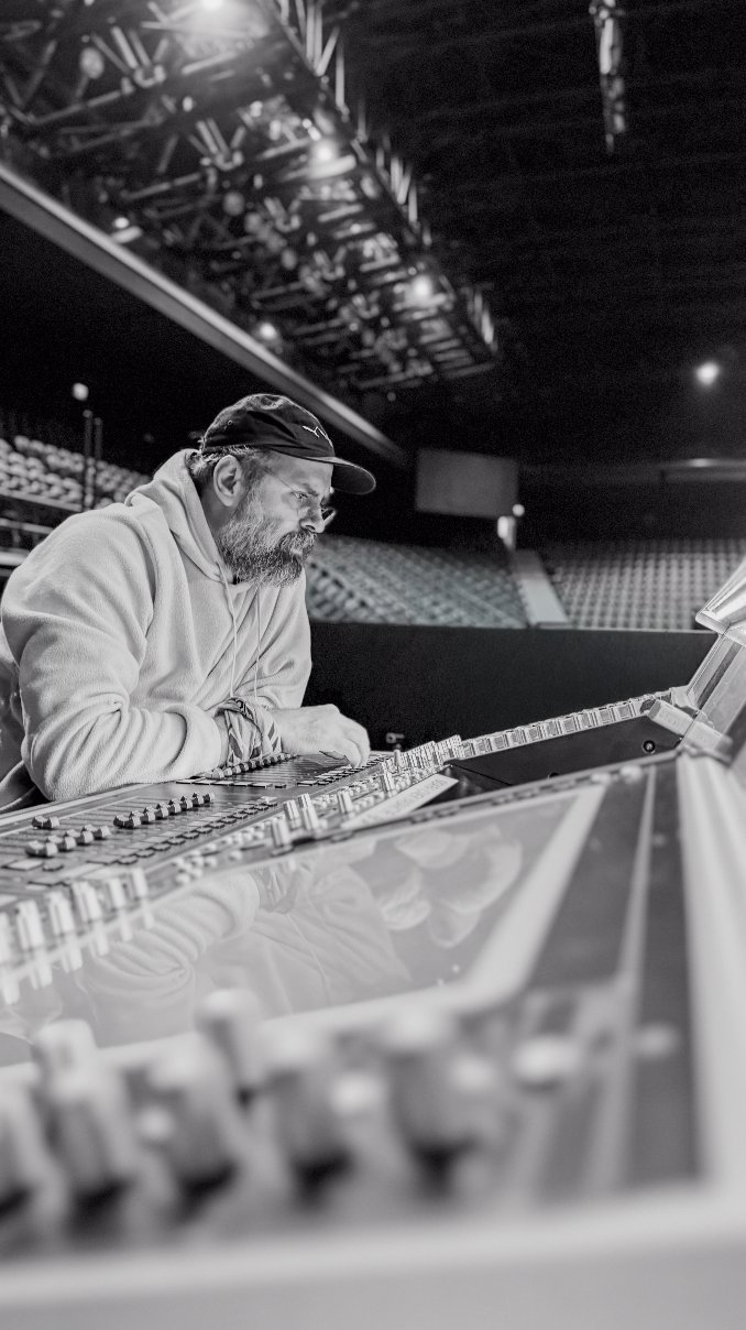 Berk Kula at the mixing desk during a live sound rehearsal